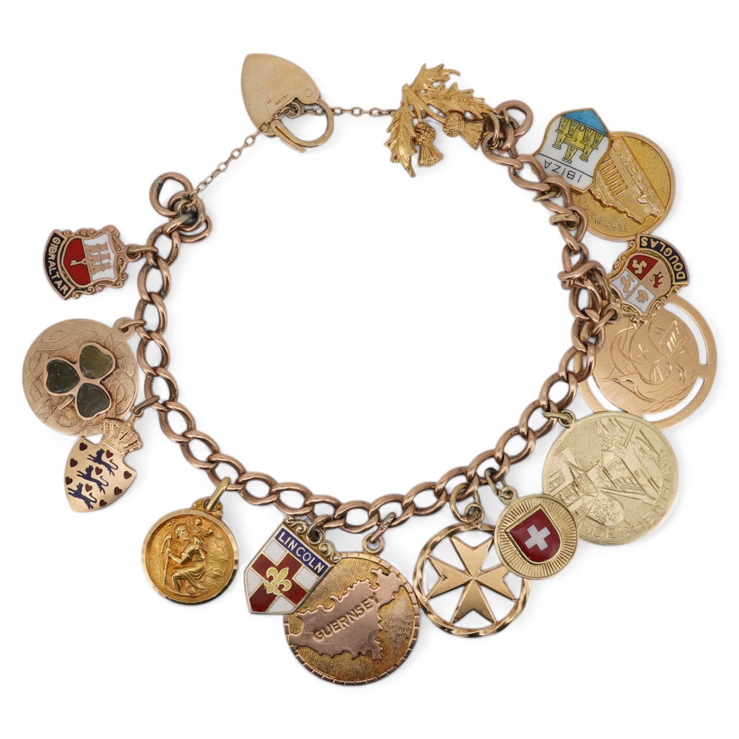 A 9ct gold charm bracelet, with heart shaped clasp, hung with fourteen assorted charms including five 9ct, two 14k and two 18k and five unmarked, gross weight 39 grams. Condition - fair